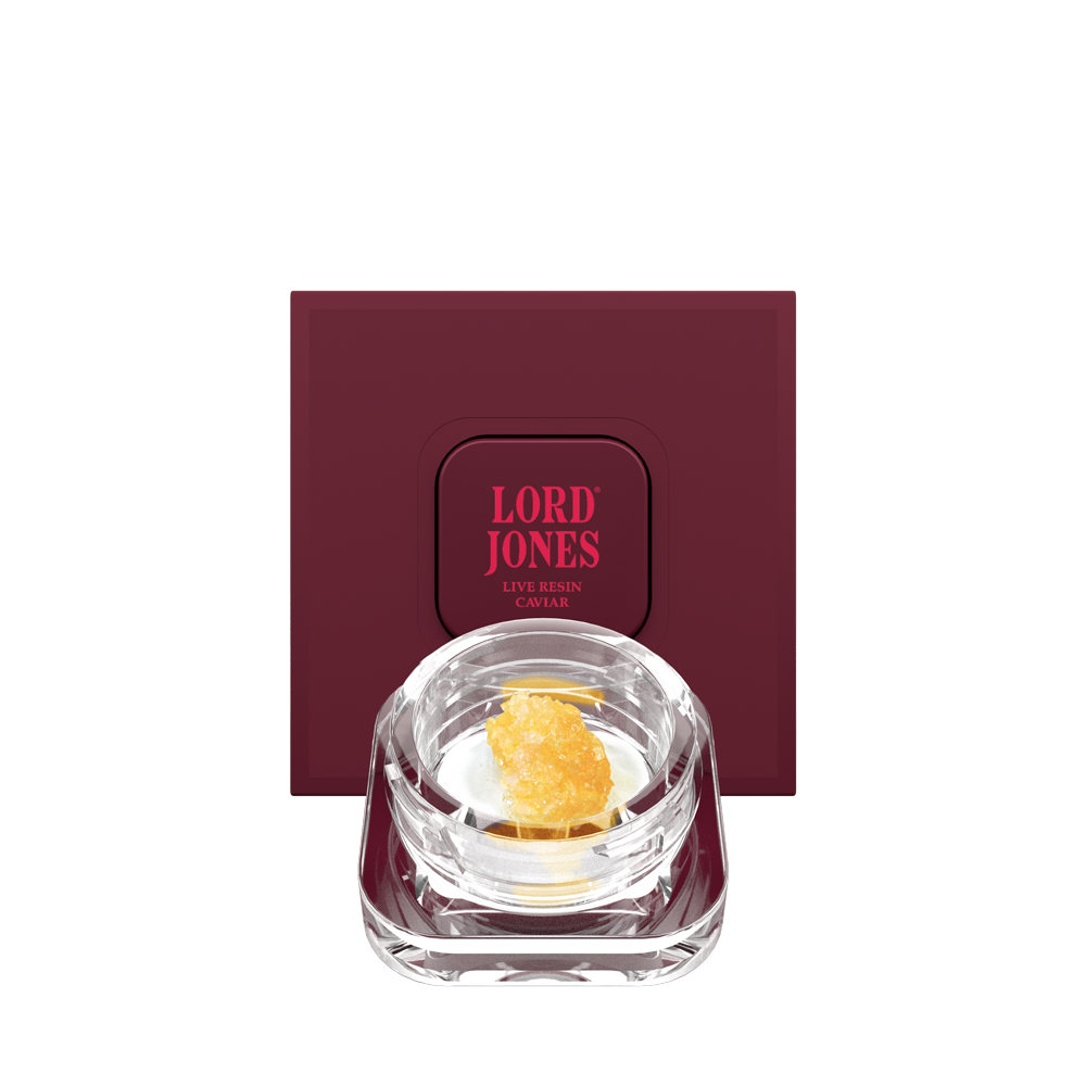 Orange Velvet Live Resin Caviar concentrate in a glass jar surrounded by bright citrus tones, representing premium cannabis extract available at Grassroots Cannabis in Windsor, Ontario.