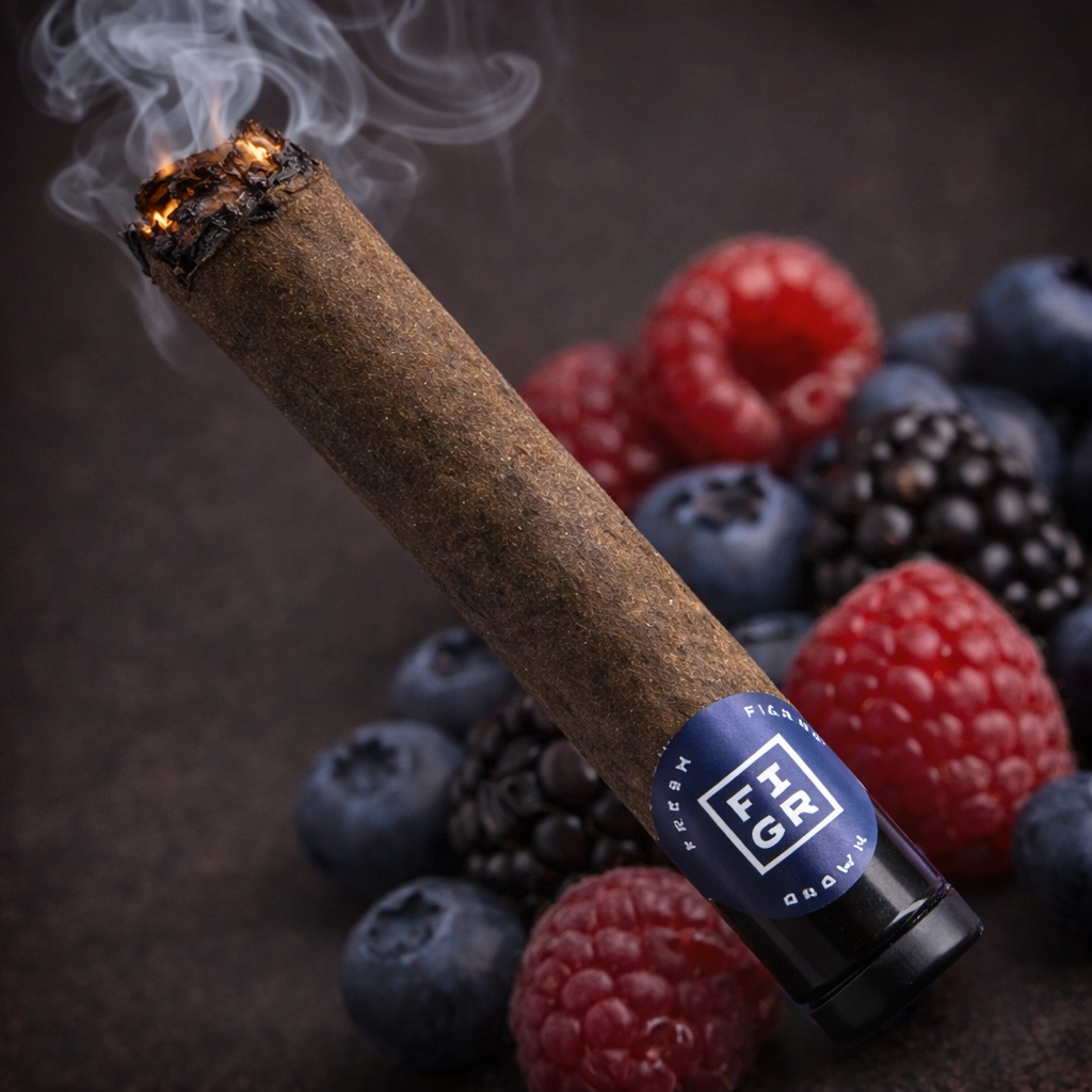 Kandy Cake Premium Glass Tip Blunt by FIGR with berry background and visible smoke from lit tip